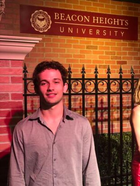 Eli Brown in a brown shirt poses at Beacon Heights.